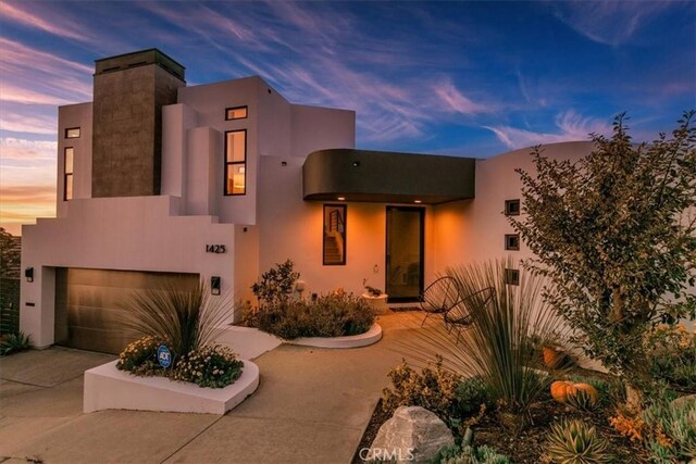 1425 Skyline Dr, Laguna Beach, CA 92651 - view of front of house with an attached garage, driveway, and stucco siding