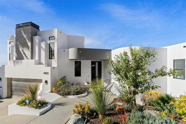 1425 Skyline Dr, Laguna Beach, CA 92651 - view of front of home with stucco siding, a garage, and driveway