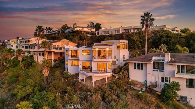 1425 Skyline Dr, Laguna Beach, CA 92651 - back of property at dusk with a balcony, stucco siding, and a residential view