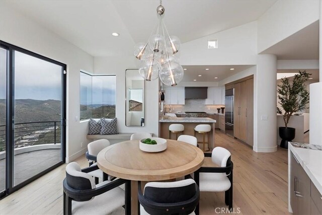 1425 Skyline Dr, Laguna Beach, CA 92651 - dining space with light wood-style flooring, a chandelier, recessed lighting, and vaulted ceiling