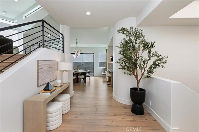 1425 Skyline Dr, Laguna Beach, CA 92651 - hallway featuring wood-type flooring, recessed lighting, an upstairs landing, and a chandelier