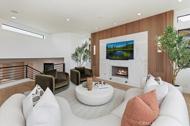 1425 Skyline Dr, Laguna Beach, CA 92651 - living room featuring a high end fireplace, wood finished floors, and recessed lighting