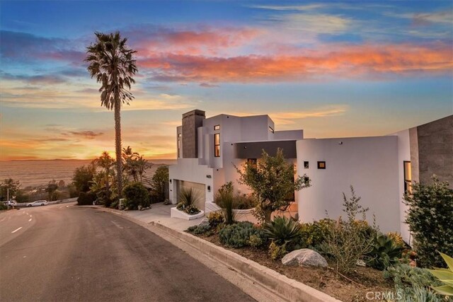 1425 Skyline Dr, Laguna Beach, CA 92651 - contemporary home with an attached garage, stucco siding, and driveway