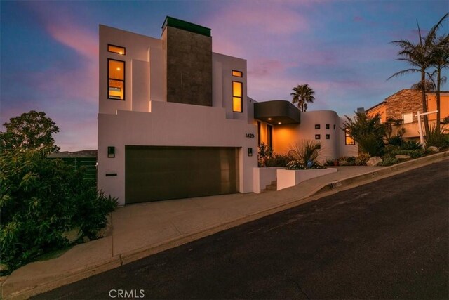 1425 Skyline Dr, Laguna Beach, CA 92651 - view of front of property with an attached garage, stucco siding, and concrete driveway