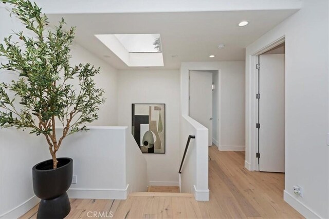 1425 Skyline Dr, Laguna Beach, CA 92651 - hall featuring a skylight, an upstairs landing, wood finished floors, and recessed lighting