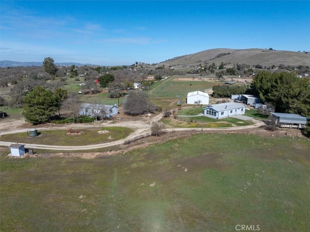 birds eye view of property with a mountain view and a rural view