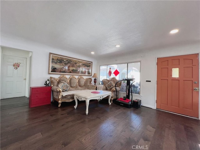 foyer with a textured ceiling and dark wood-type flooring