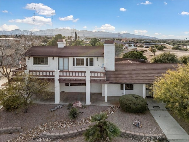 view of front of property with a deck with mountain view