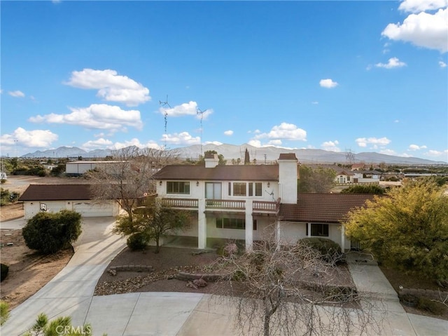 view of front facade featuring a mountain view and a garage