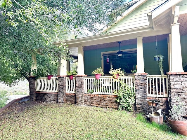 view of home's exterior with ceiling fan and a porch