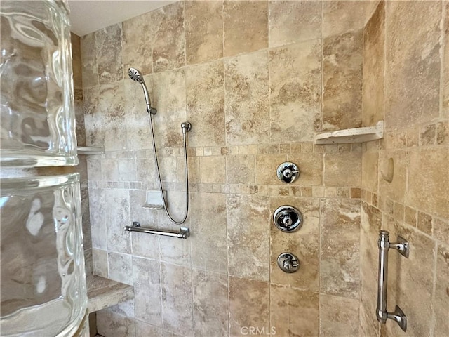 bathroom with a tile shower