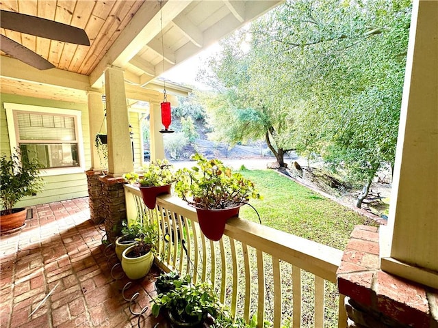 view of yard featuring a porch and ceiling fan