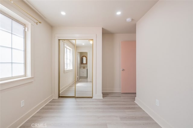 spare room featuring light hardwood / wood-style flooring and plenty of natural light