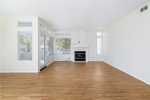 unfurnished living room featuring light hardwood / wood-style floors and a fireplace