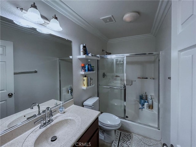 bathroom with visible vents, ornamental molding, toilet, a shower stall, and vanity