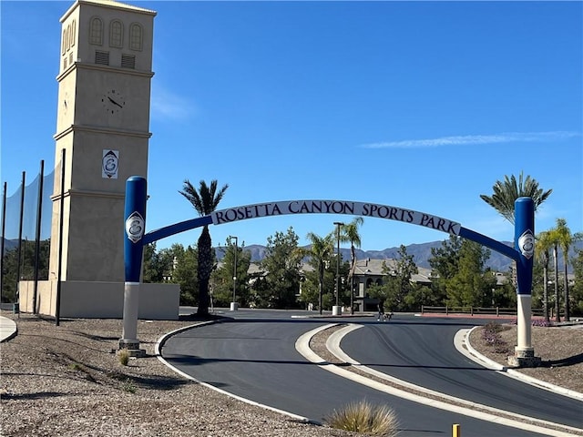 view of road with a mountain view and curbs