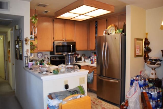 kitchen featuring appliances with stainless steel finishes and kitchen peninsula