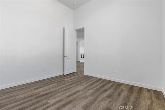 spare room featuring dark wood-type flooring