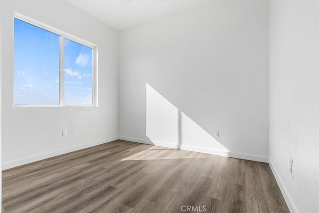 empty room with hardwood / wood-style flooring