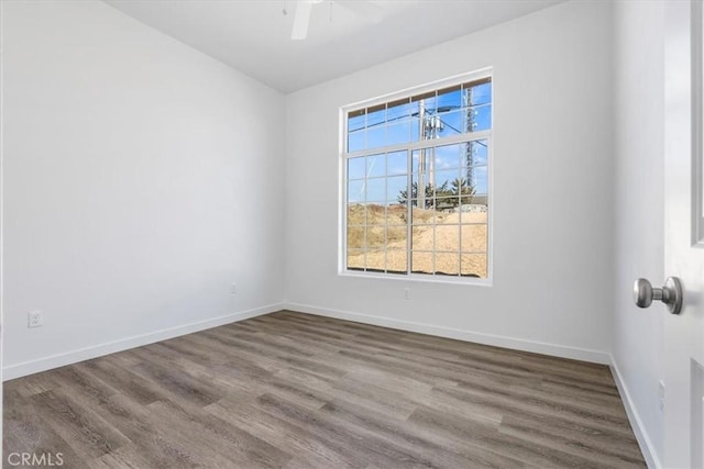 unfurnished room featuring hardwood / wood-style flooring and ceiling fan