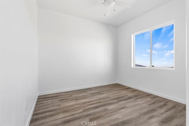 unfurnished room with hardwood / wood-style flooring and ceiling fan