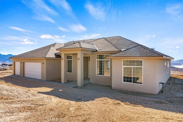 view of front of property with a mountain view and a garage