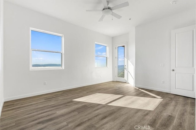 spare room featuring dark hardwood / wood-style floors and ceiling fan