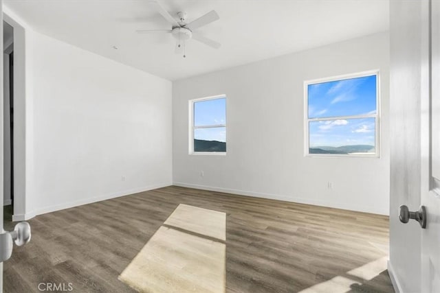 unfurnished room with hardwood / wood-style flooring and ceiling fan