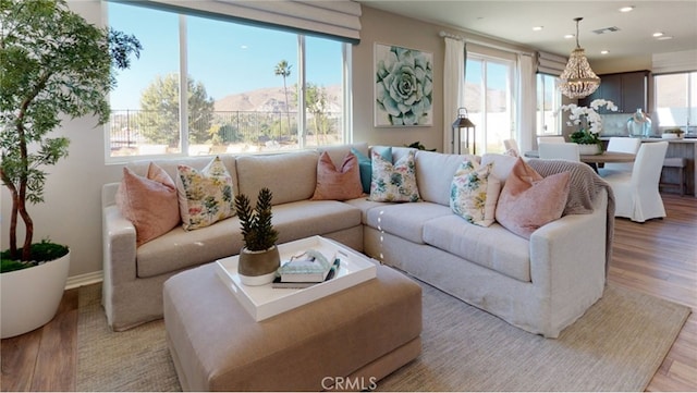 living room with a healthy amount of sunlight and light hardwood / wood-style floors