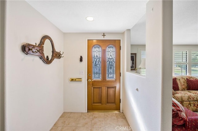 foyer entrance featuring baseboards