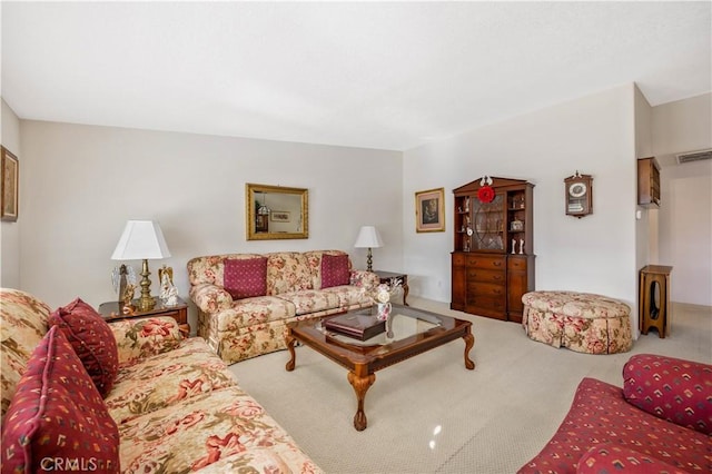 living area with visible vents and carpet flooring