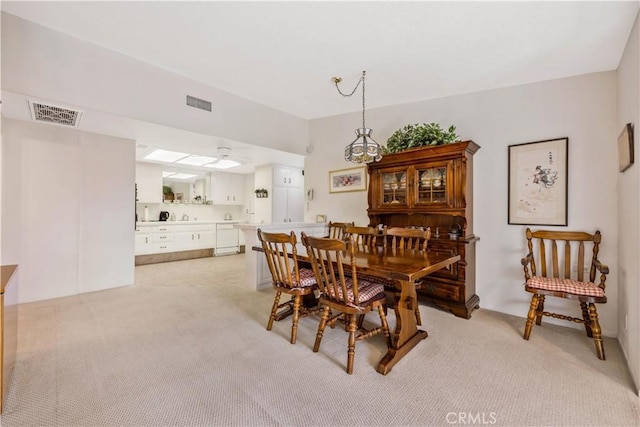 dining area featuring ceiling fan, visible vents, and light colored carpet