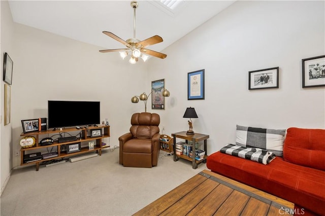 living area with lofted ceiling, carpet flooring, and ceiling fan