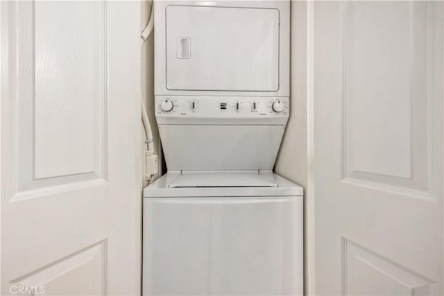 laundry room featuring stacked washer and dryer and laundry area