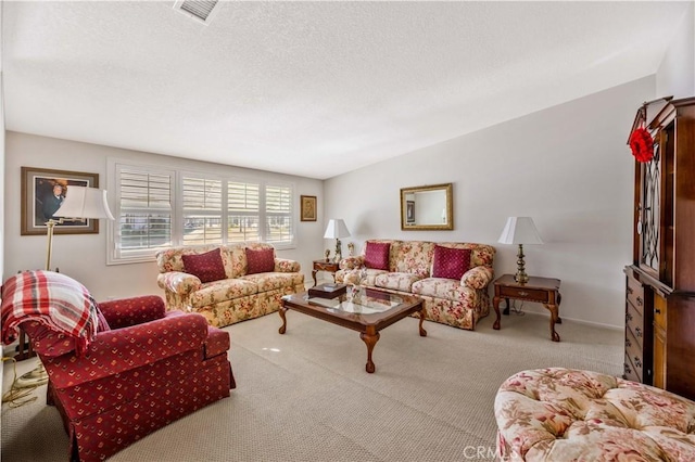 carpeted living room featuring a textured ceiling and visible vents