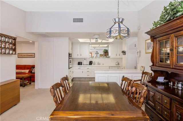 dining area featuring visible vents and light colored carpet