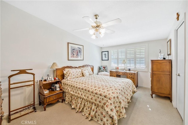 bedroom featuring light carpet and a ceiling fan