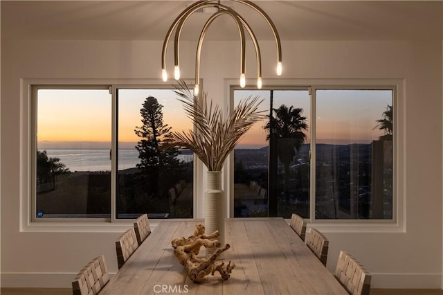 dining space with a water view and wood finished floors