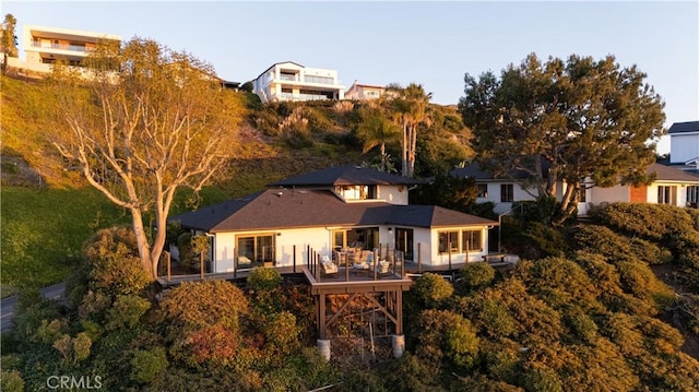 rear view of house featuring a wooden deck