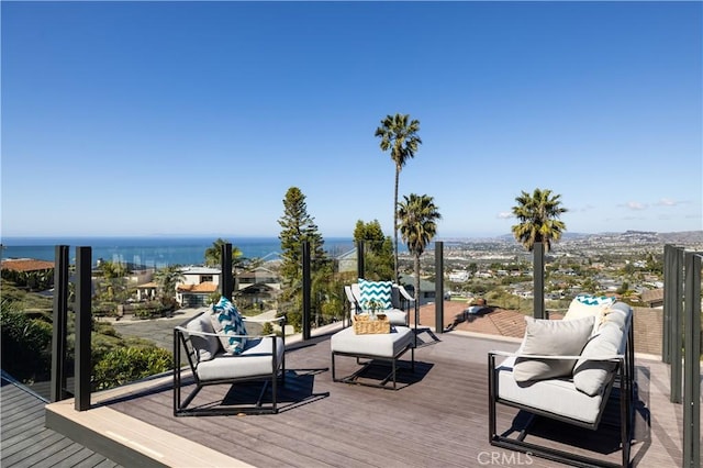 deck with outdoor lounge area and a water view