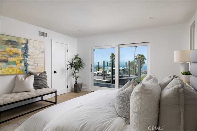 bedroom with access to outside, light wood-style flooring, visible vents, and baseboards