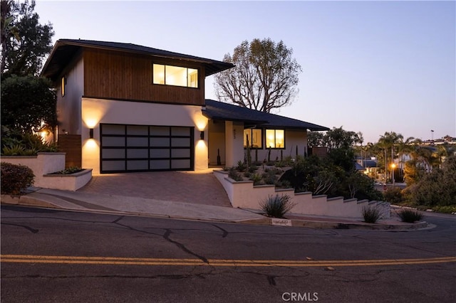 view of front of property featuring decorative driveway and an attached garage