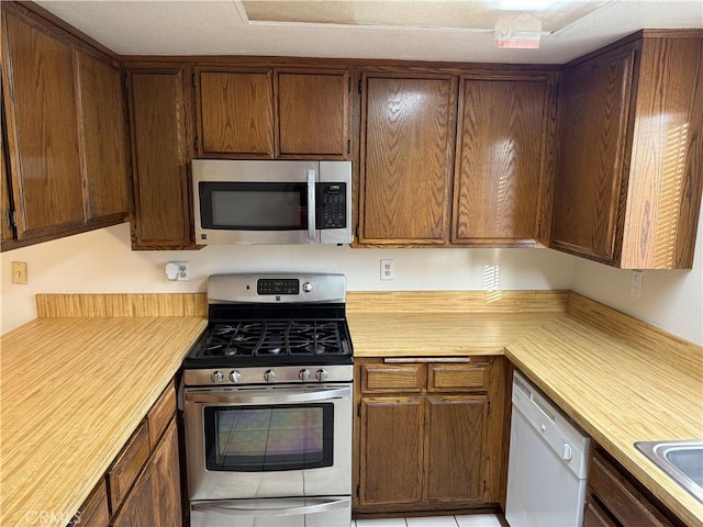 kitchen featuring stainless steel appliances and light countertops