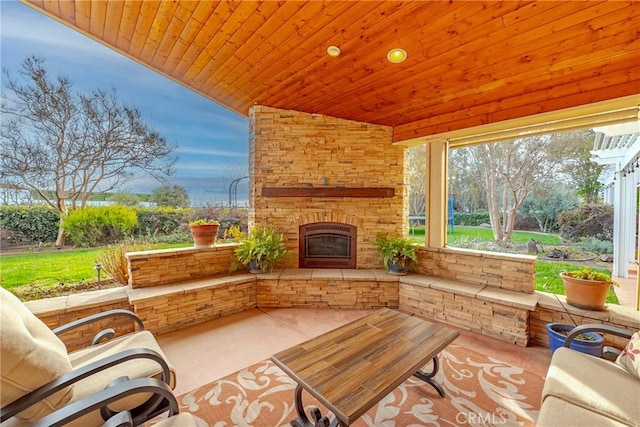 view of patio featuring an outdoor stone fireplace