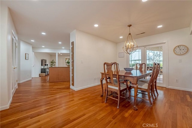 dining space with a chandelier and hardwood / wood-style floors