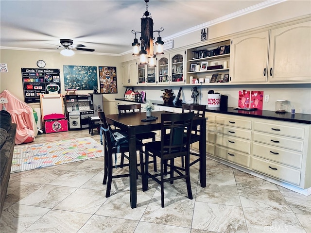 dining room with marble finish floor, a ceiling fan, and crown molding