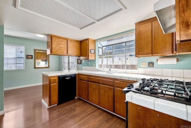 kitchen with black dishwasher, brown cabinets, and gas stovetop