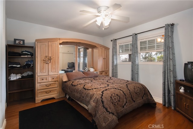 bedroom with ceiling fan and dark hardwood / wood-style floors