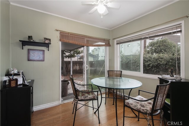 dining area featuring ceiling fan, crown molding, and wood-type flooring