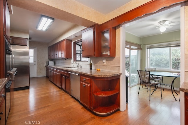 kitchen featuring ceiling fan, light hardwood / wood-style flooring, stainless steel appliances, and sink